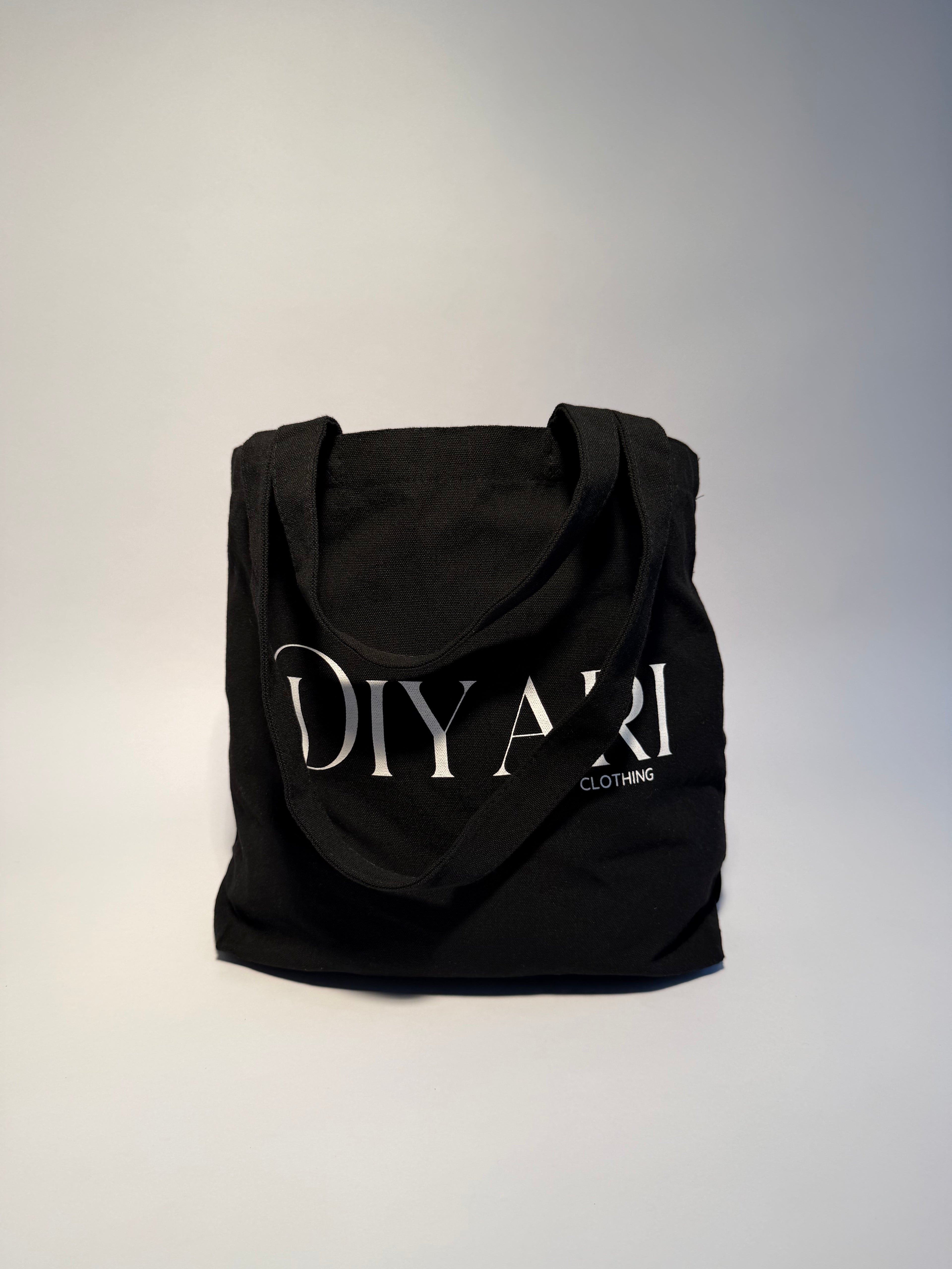 Black hoodie with 'DIYARI' branding on a light gray background