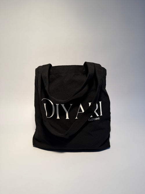 Black hoodie with 'DIYARI' branding on a light gray background